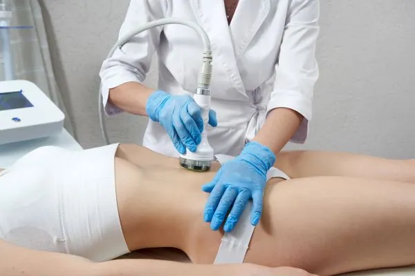 Lost the Weight but Not the Loose Skin? 2 woman having HIFU treatment on her stomach to combat loose skin Gerrards Cross following weight loss